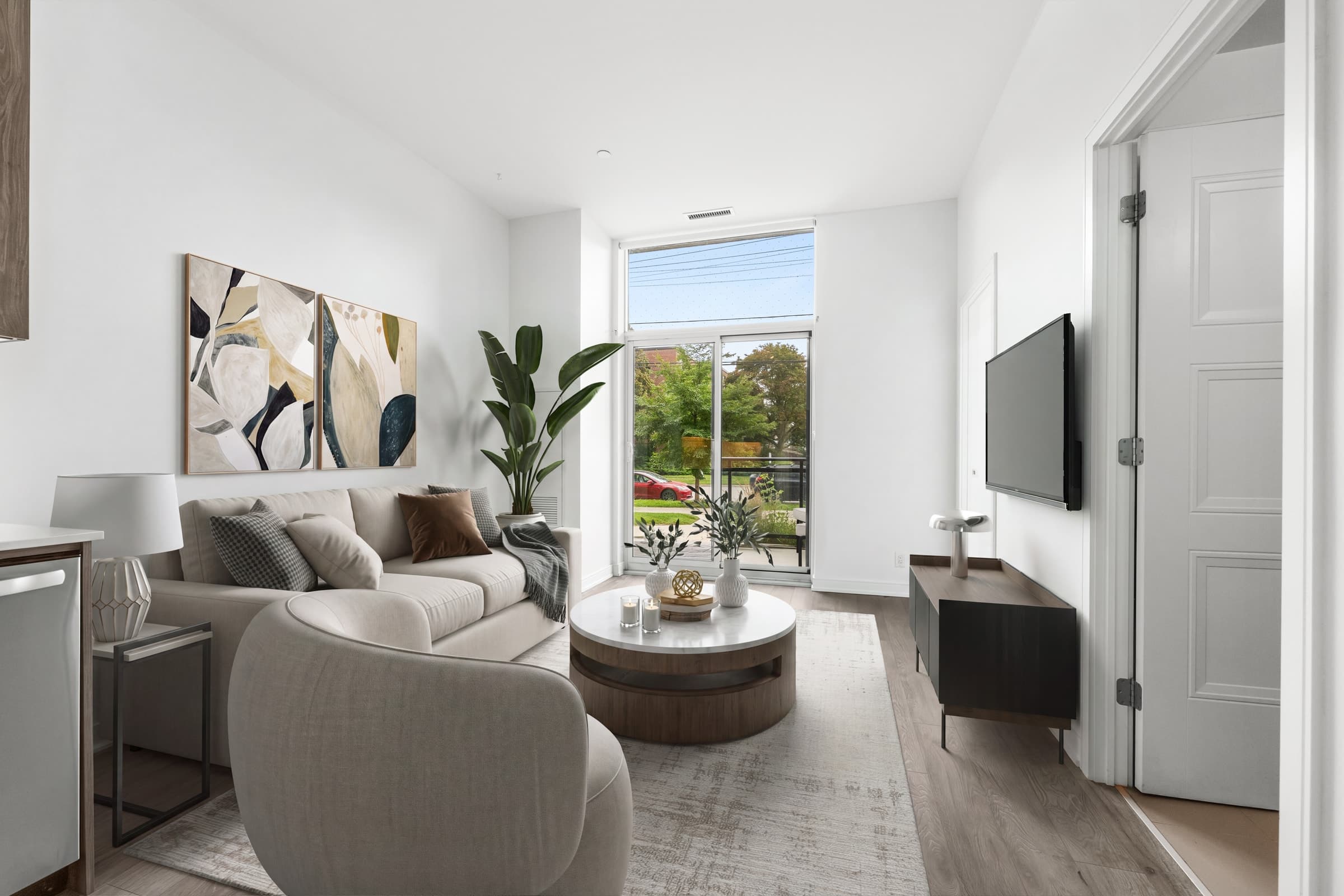 Living room virtually staged with sofa, armchair, coffee table, rug, artwork and TV furniture