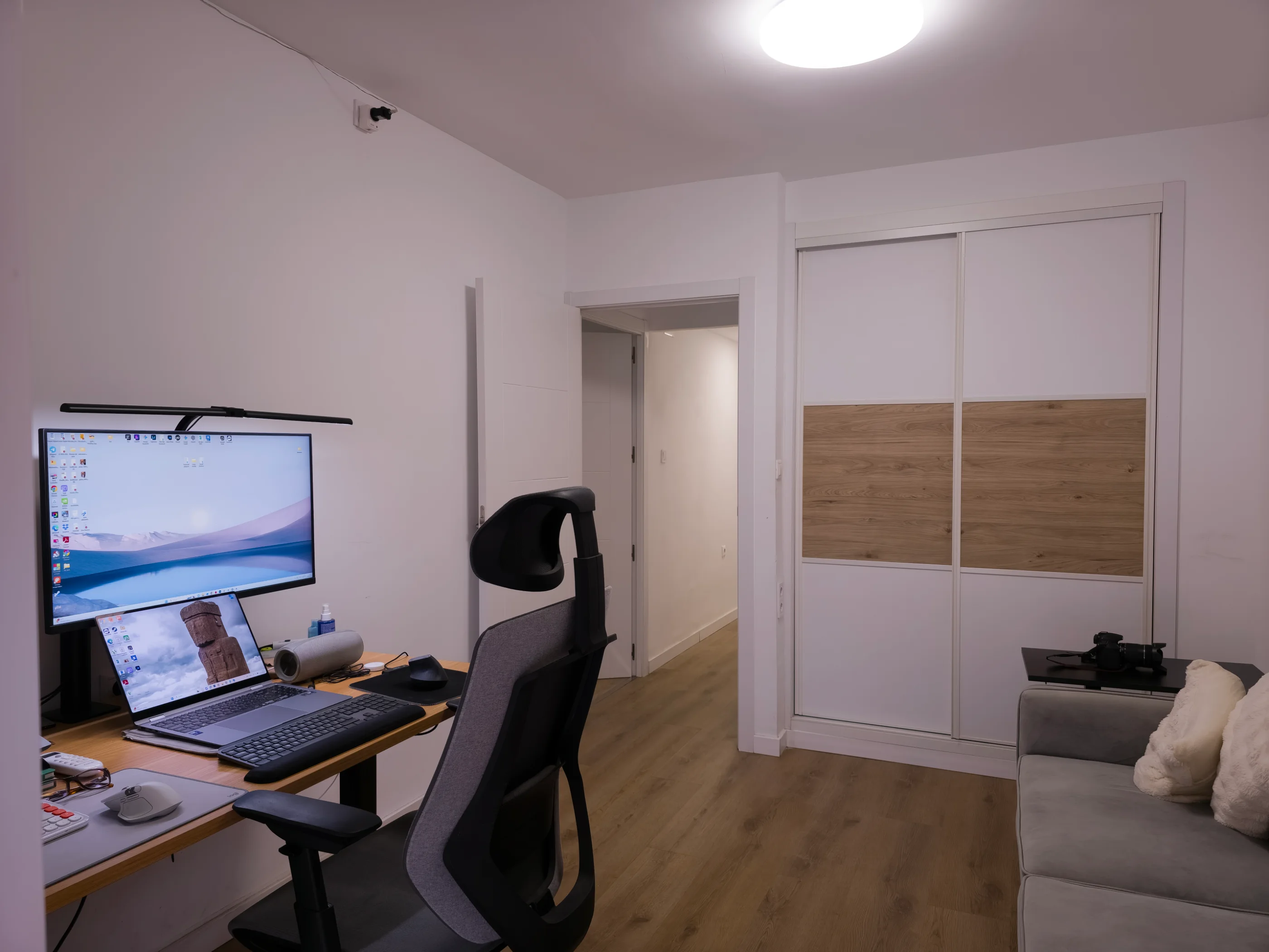 Before image enhancement: Open-plan living room interior with neutral walls, seating, and natural daylight